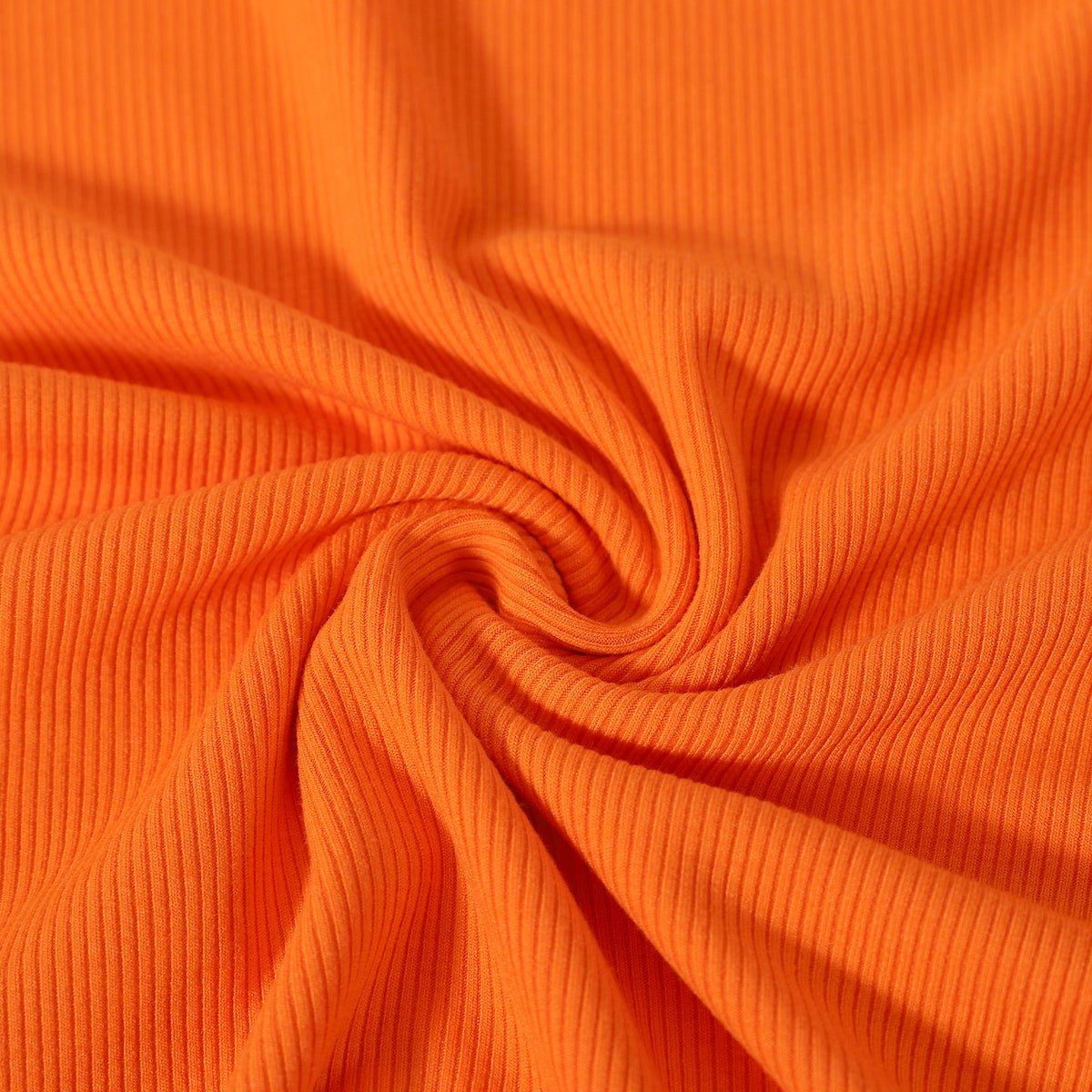 Close-up of orange ribbed fabric top