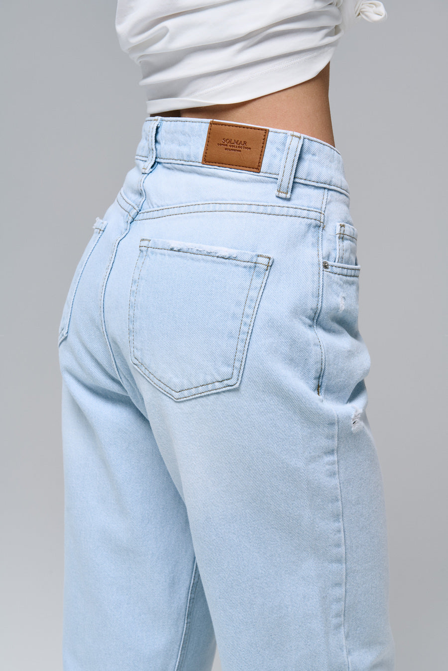 STRAIGHT jeans in light blue color with distressed details